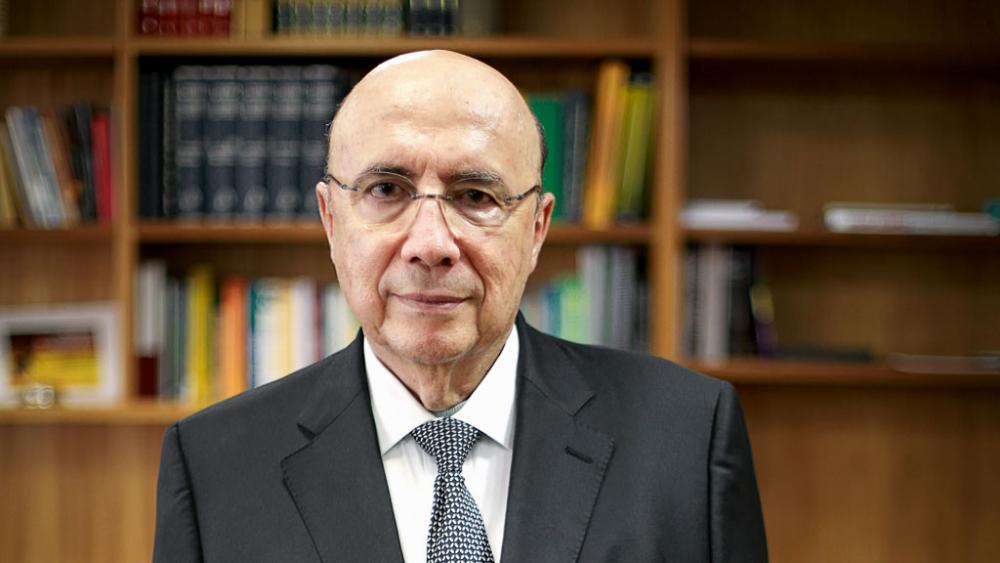 Henrique Meirelles muda de tática e ‘cola’ em Lula